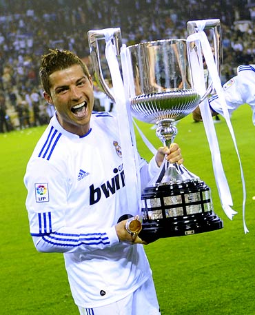 Cristiano Ronaldo celebrates with the trophy after winning the King's Cup final against Barcelona