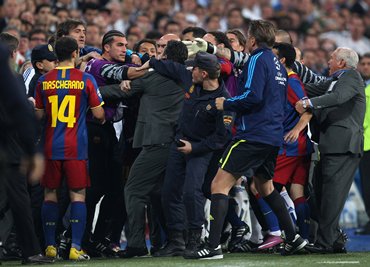 Barcelona's reserve 'keeper Jose Pinto clashes with a Real Madrid official