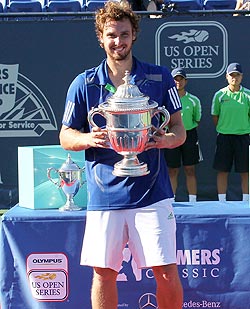 Ernests Gulbis of Latvia holds the trophy after defeating Mardy Fish to claim the LA International title