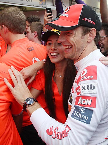 McLaren's Jenson Button celebrates with his girlfriend Jessica Michibata after winning the race