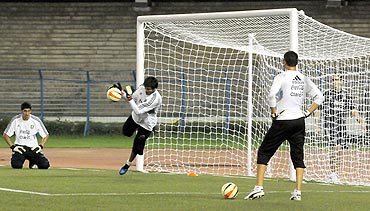 Argentina 'keepers Sergio Romero, Esteban Andrada and Mariano And jar go through the grind during a training session