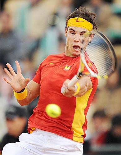 Rafael Nadal of Spain plays a backhand to Juan Monaco of Argentina