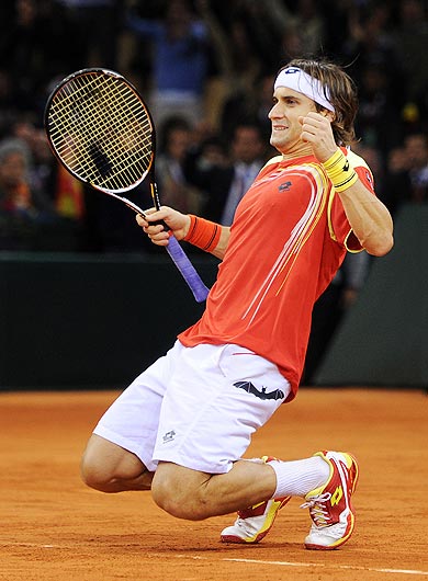 David Ferrer of Spain goes on his knees celebrating matchpoint over Juan Martin del Potro of Argentina