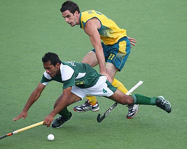 Pakistan's Rashid Mehmood trips after a challenge from Australia Kieran Govers during the match on Tuesday