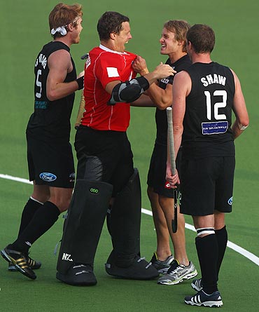 New Zealand's goal keeper Stephen Graham celebrates with teammates after their draw against The Netherlands on Tuesday