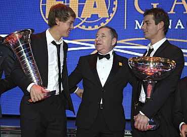 FIA President Jean Todt poses with Formula One World Champion Sebastien Vettel and Rally World Champion Sebastien Loeb during the 2010 FIA Prize Giving gala in Monaco