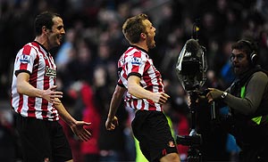 Sunderland's Sebastian Larsson (right) and John O' Shea celebrate the winning goal
