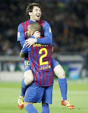 Barcelona's Lionel Messi and Dani Alves celebrate after winning the Club World Cup final against Santos