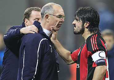 AC Milan's Gennaro Gattuso (right) argues with Tottenham Hotspur's assistant coach Joe Jordan (centre) as manager Harry Redknapp tries to seprerate them on Tuesday