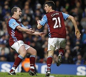 Aston Villa's Richard Dunne is ecstatic after teammate Ciaran Clark (right) scored the injury-time equaliser against Chelsea on Sunday