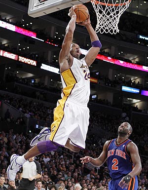 Los Angeles Lakers Kobe Bryant (left) slam dunks over New York Knicks Raymond Felton