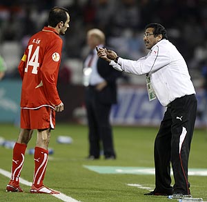 Bahrain's coach Salman Sharida gives instructions to Salman Isa (left) during their Asian Cup match against India on Friday