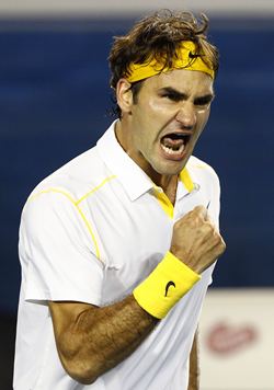 Federer celebrates after beating Simon