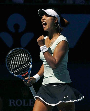 Li Na of China celebrates after defeating Caroline Wozniacki of Denmark