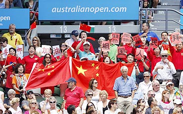 Fans of Li Na cheer during her semi-final match against Caroline Wozniacki