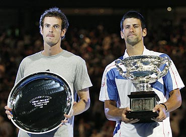 Novak Djokovic and Andy Murray (left) with their trophies after their men's singles final on Sunday