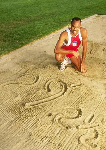 Mike Powell stands behind long jump record set by Bob Beamon at the 1968 Mexico Olympics. He broke it by 5 cms 92 inches) in Tokyo in 1991