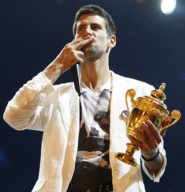 Novak Djokovic greets supporters upon arrival in Belgrade on Monday