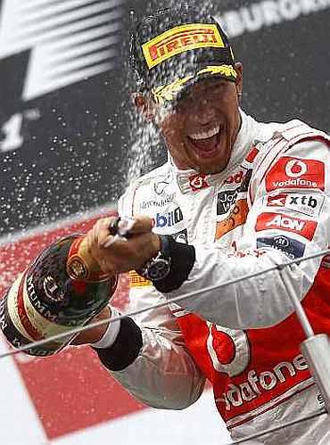 Lewis Hamilton celebrates after winning the German Grand Prix