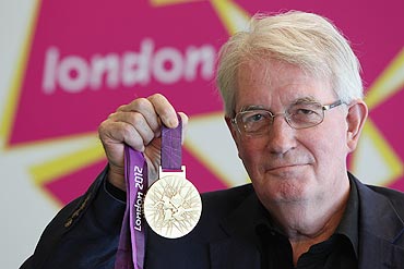 Designer David Watkins poses with the 2012 Olympic games gold medal