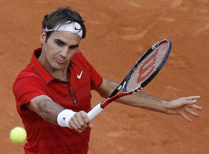 Roger Federer returns