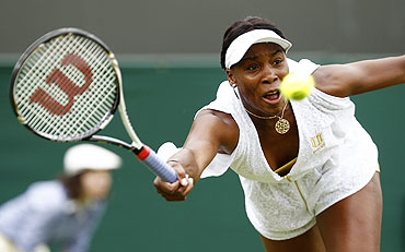 Venus Williams stretches to hit a return to Akgul Amanmuradova