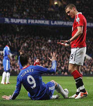 Manchester United's Nemanja Vidic (right) exchanges words with Chelsea's Fernando Torres