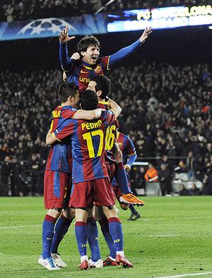 Barcelona's Lionel Messi (centre) celebrates with teammates after scoring his second goal 