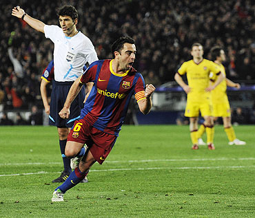 Barcelona's Xavi Hernandez (centre) celebrates after scoring against Arsenal