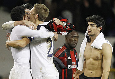 AC Milan's Pato (right) reacts as Tottenham Hotspur players celebrate after making it to the quarter-finals following a draw on Wednesday
