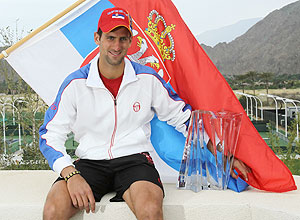 Novak Djokovic poses with the trophy following his victory over Rafael Nadal in the Indian Wells final
