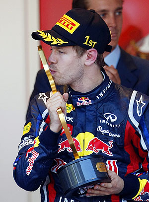 Red Bull's Sebastian Vettel of Germany kisses his trophy on the podium as he celebrates winning the Monaco F1 Grand Prix