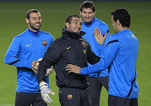 Barcelona's players (left to right) Sergio Busquets, Jose Pinto, Lionel Messi and Javier Mascherano share a laugh during a practice session in Prague