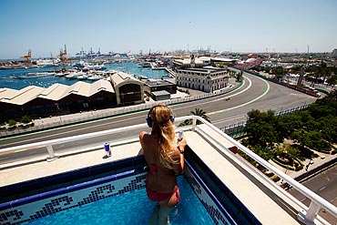 Fans watch from a rooftop pool during the European Formula One Grand Prix at the Valencia Street Circuit