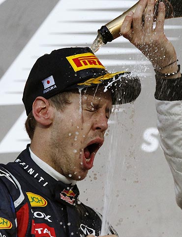 Sebastian Vettel is drenched in champagne after the Japan GP on Sunday