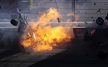 The car of Dan Wheldon (top left) bursts into flames during the Las Vegas Indy 300 part of the IZOD IndyCar World Championships