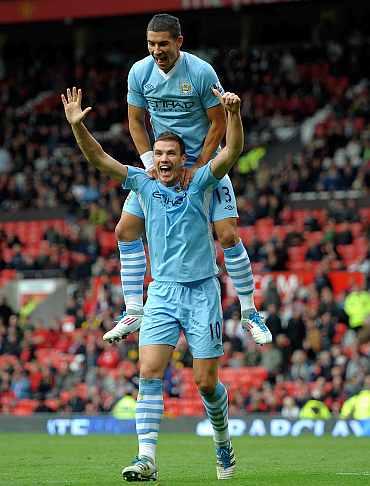 Manchester City's Edin Dzeko celebrates after scoring against Manchester United