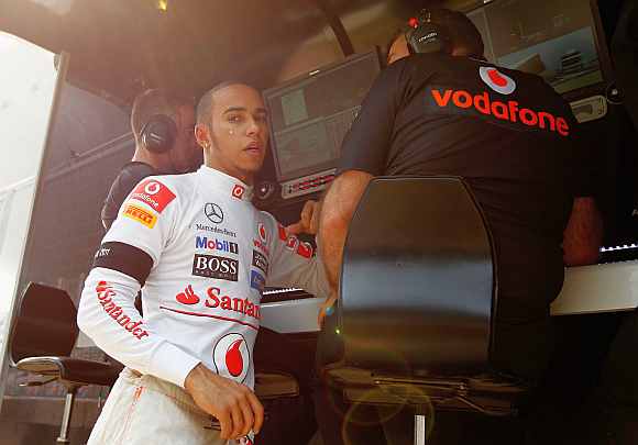 McLaren's Lewis Hamilton is seen on the pitwall following first practice for the Indian Formula One Grand Prix at the Buddh International Circuit