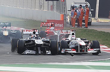 Rubens Barrichello (left) of Brazil and Williams loses his front wing in a collision with Kamui Kobayashi (right) of Japan and Sauber F1 during the Indian GP