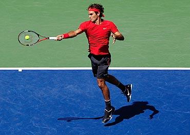 Roger Federer returns a shot against Dudi Sela