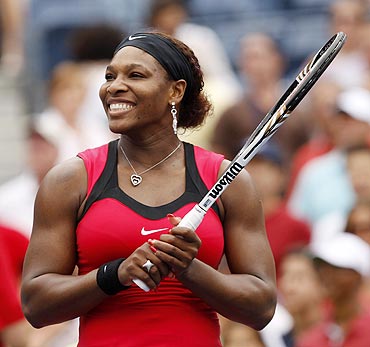 Serena Williams smiles after defeating Ana Ivanovic