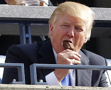 Donald Trump enjoys an ice-cream during the opening match of the US Open between  Maria Sharapova and Heather Watson