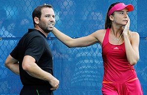 Daniela Hantuchova of Slovakia and golfer Sergio Garcia look on after they hit balls together on a practice court in New York on Wednesday