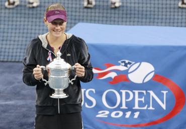 Samantha Stosur of Australia poses with her trophy during the presentation ceremony after defeating Serena Williams in the final