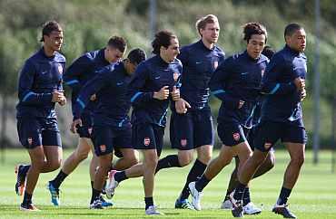 Arsenal players during a warm up session ahead of their UEFA Champions League Group match against Borussia Dortmund, London Colney