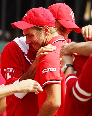 Stanislas Wawrinka (right) celebrates with Roger Federer after defeating Australia's Lleyton Hewitt