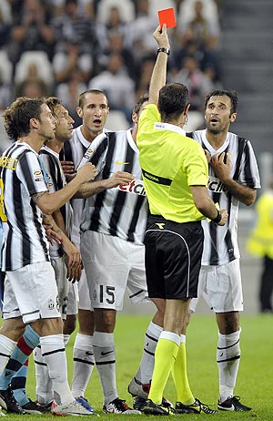 Juventus's Mirko Vucinic (right) is shown the red card during their Serie A soccer match against Bologna