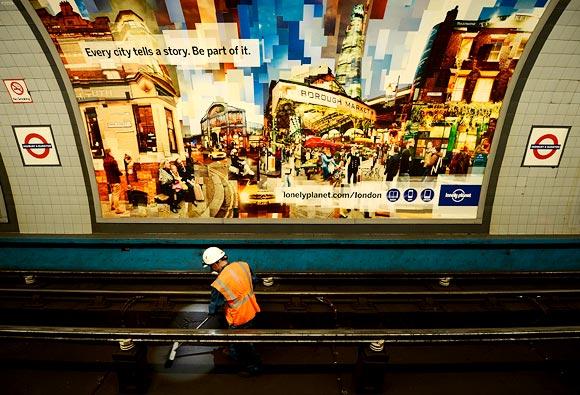 A cleaner, known as a fluffer, works at Highbury and Islington underground tube station on the Victoria Line in London.