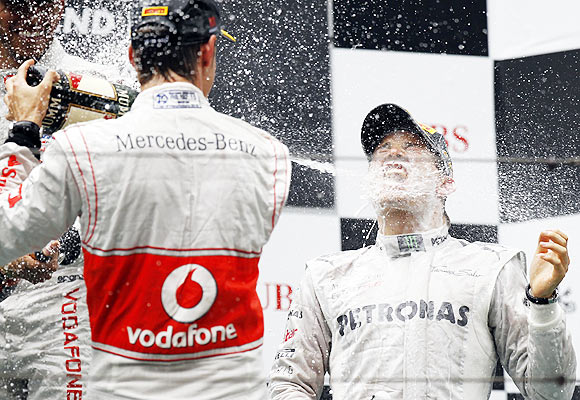 Mercedes Formula One driver Nico Rosberg of Germany is sprayed with champagne during the podium ceremony