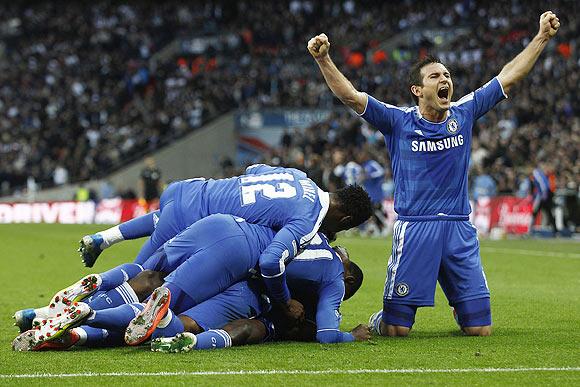 Chelsea's Frank Lampard (right) celebrates as his teammates jump on Ramires after he scored the winner during their FA Cup semi-final against Tottenham Hotspur at Wembley Stadium on Sunday